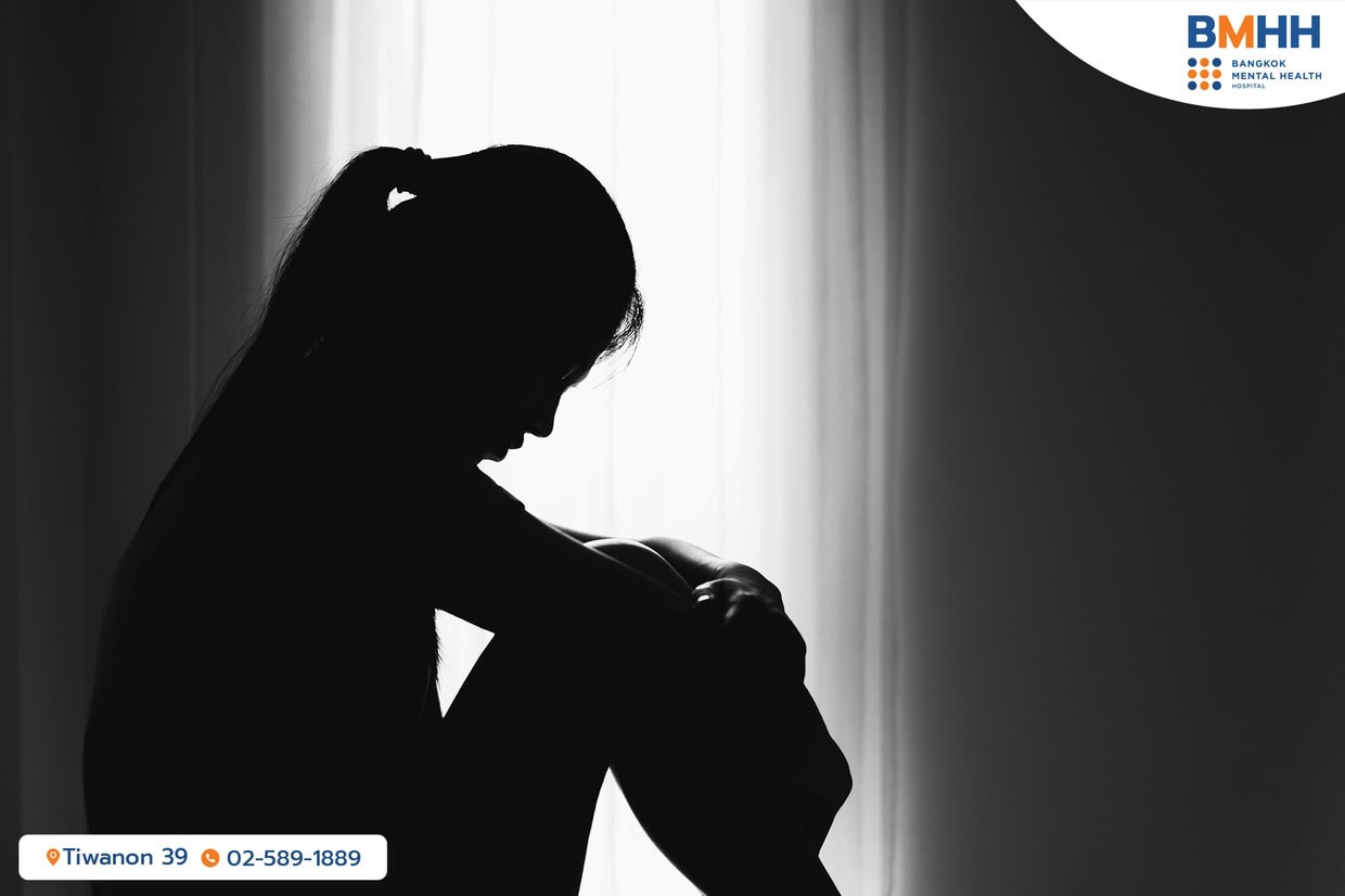 A woman sitting on the floor, depressed due to adjustment disorder