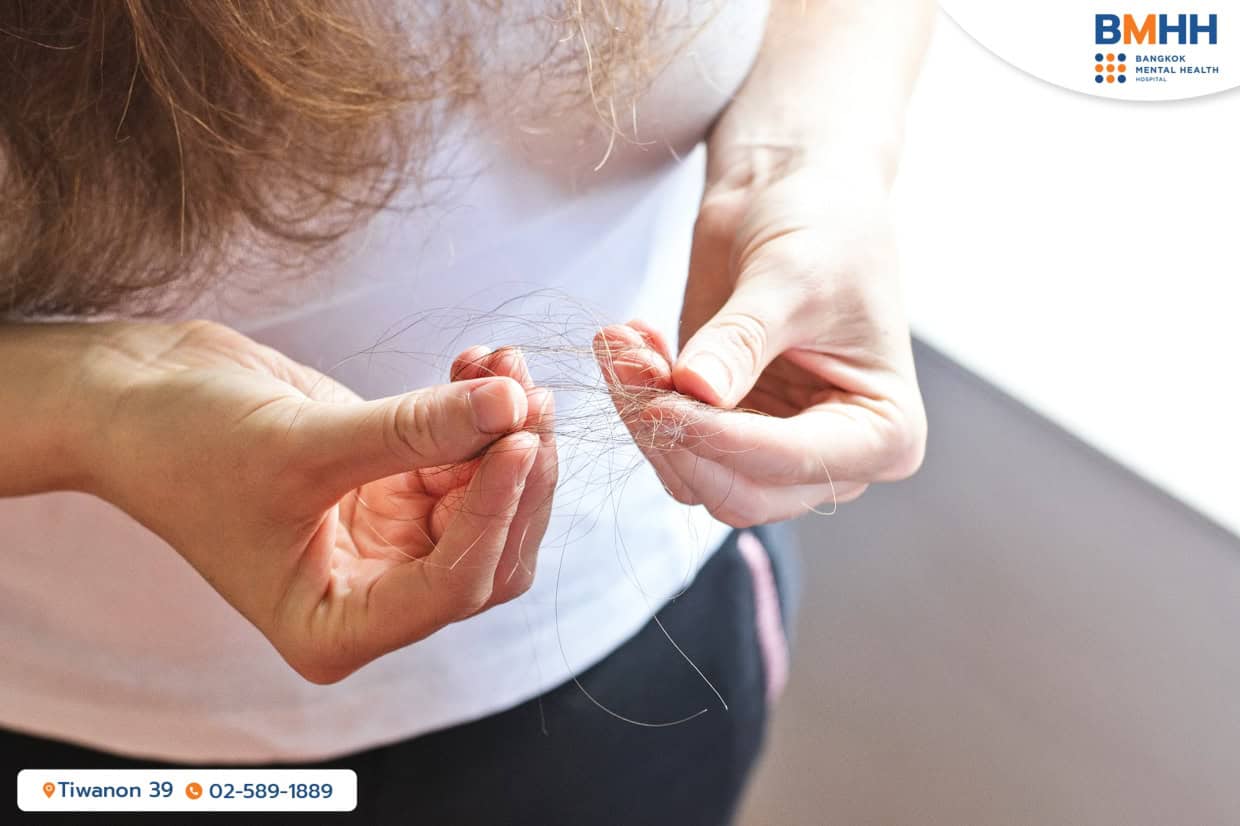 A woman holding fallen hair from trichotillomania