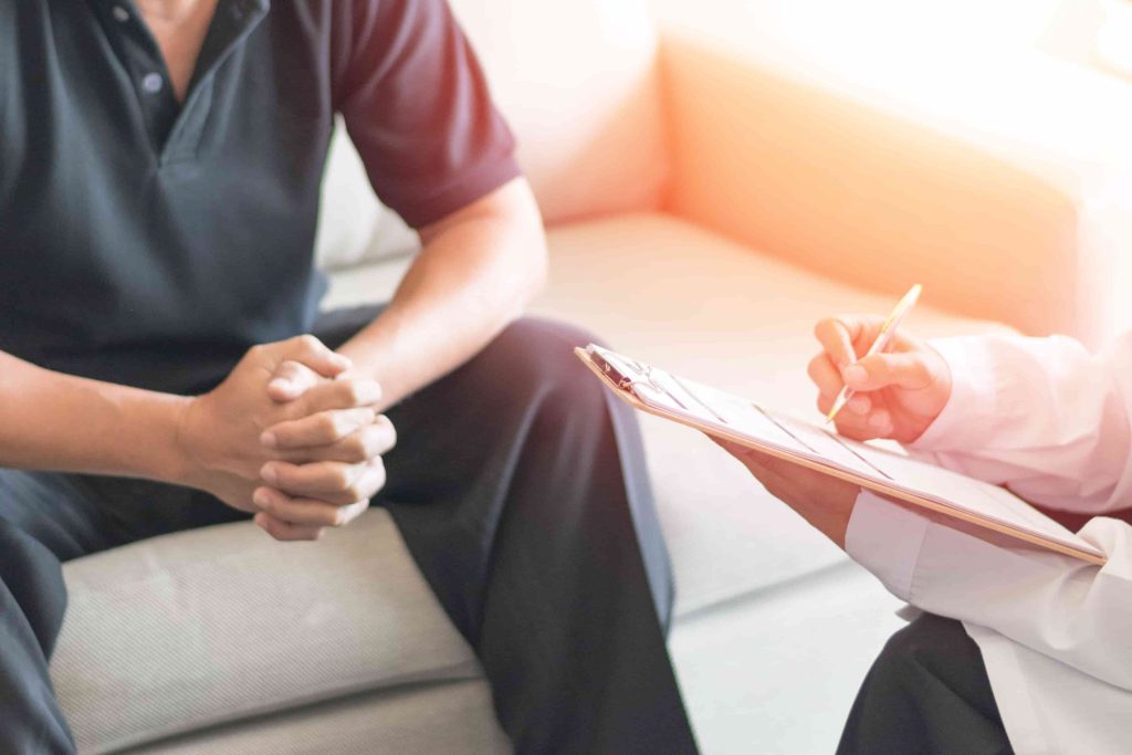 A man in a therapy session for adjustment disorder